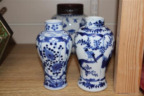 A 19th century Chinese blue and white ovoid jar, wood cover and two similar smaller vases tallest 15cm